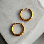 Boucles d’oreilles essentielles ◦ Anneau huggie doré